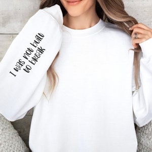 Sweater with outlet writing on sleeves