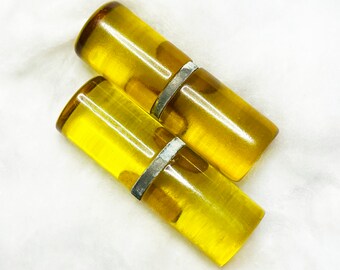 a pair of apple juice bakelite toggle buttons