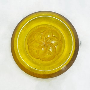 a chunky carved applejuice bakelite button