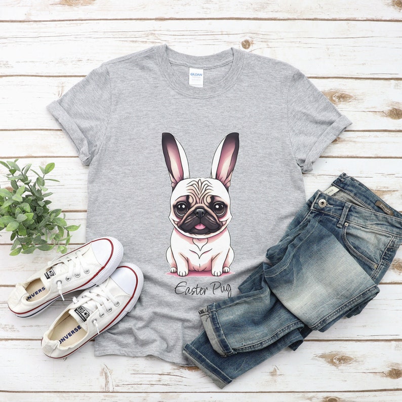 May include: A grey t-shirt featuring a cartoon pug wearing bunny ears. The text "Easter Pug" is printed below the image.