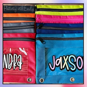 May include: A collection of rectangular zippered pouches in various colors including lime green, hot pink, dark blue, bright blue, red, gray, and orange. Each pouch features a clear plastic window, a black zipper, and two metal-reinforced holes.