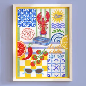 May include: A framed print with Italian illustrations. It features a red lobster, sardines, a slice of grapefruit, a chilli pepper, tomatoes, sunglasses, and the text "Ciao" and "La vita è bella". The background includes blue and yellow patterns.