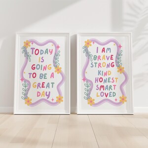 May include: Two framed art prints with inspirational quotes. The left print reads "TODAY IS GOING TO BE A GREAT DAY" in colorful text. The right print says "I AM BRAVE STRONG KIND HONEST SMART LOVED". Both have floral and star accents.