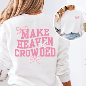 May include: White sweatshirt with the text "MAKE HEAVEN CROWDED" in pink letters. There are pink bows on the sweatshirt.