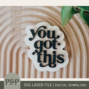 May include: A wooden sign with the phrase "You got this" in black script. The sign is in a cloud shape and sits on a light brown, textured surface. The bottom of the image includes the text "SVG LASER FILE | DIGITAL DOWNLOAD".