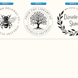 May include: Three circular black ink stamps on a light background. The first features a bee with the text THIS BOOK BELONGS TO DANIELLE SKITTRAL. The second shows a tree with FROM THE LIBRARY OF DANIELLE SKITTRAL. The third has leaves and Danielle Skittral.