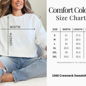 May include: A white crewneck sweatshirt with a size chart showing measurements in inches. The chart lists sizes S to 3XL, with width ranging from 21 to 29.5 inches, length from 27.5 to 32.5 inches, and sleeve length from 31.5 to 39.25 inches. The sweatshirt is labeled "1566 Crewneck Sweatshirt."