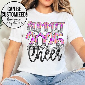 May include: White t-shirt with the text "SUMMIT 2025 Cheer" in black and white with a pink, orange, and blue abstract design.