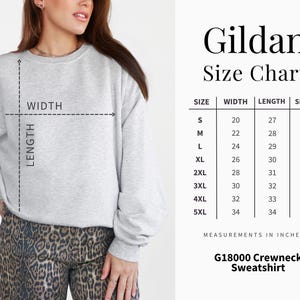 May include: A light gray Gildan G18000 crewneck sweatshirt. The image includes a size chart with measurements in inches for sizes S to 5XL. The chart shows the width, length, and sleeve measurements for each size. The model is wearing the sweatshirt.