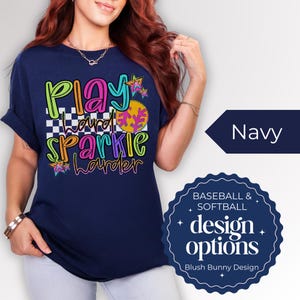Get ready for game day with our Play Hard Sparkle Harder Softball Baseball Shirt! This Gildan Unisex Tee is perfect for Softball Moms who want to shine bright while cheering on their team. Featuring a dazzling glitter design, this shirt combines comfort and style effortlessly. Whether you're in the stands or on the field, this shirt is sure to turn heads. Show your support with a touch of sparkle! 🌟 Grab yours today and elevate your gameday look!