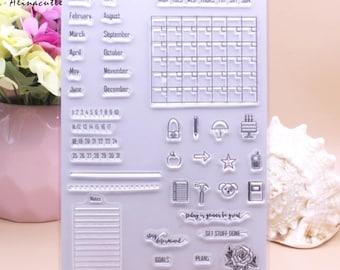 May include: Clear acrylic stamp sheet with various designs, including a calendar, a list, a note section, and a variety of icons and phrases. The phrases include "Today is gonna be great", "Get stuff done", "Stay determined", "Goals", and "Plans".