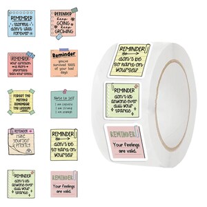 May include: A roll of stickers with various inspirational messages. The stickers are rectangular with pastel backgrounds and feature phrases like "Remember storms don't last forever" and "Your feelings are valid."
