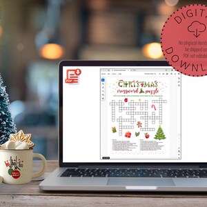 May include: A digital download of a printable Christmas crossword puzzle. The puzzle features a festive design with a Christmas tree, candy canes, and a gingerbread man. The text "CHRISTMAS crossword puzzle" is at the top of the puzzle.
