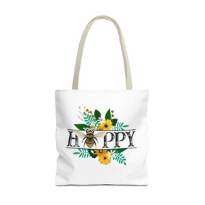 May include: A white tote bag with a bee and floral design. The text "HAPPY" is written in black with a vintage style font.
