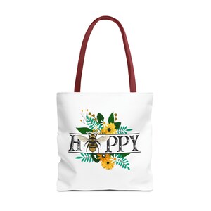 May include: White tote bag with a burgundy handle. The bag has a floral design with a bee in the center and the word "HAPPY" written in black letters.