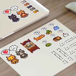 May include: A collection of pixel art cat stickers and a print with various cat designs, speech bubbles, and the text "I'm starting to feel exhausted." The stickers are on a laptop, and the print is on a wooden surface.