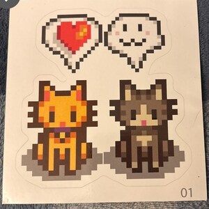 May include: Two pixel art cats, one orange and one gray, with speech bubbles above them. The orange cat has a purple collar. The speech bubbles contain a red heart and a white smiling face.