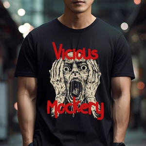 Può includere: Maglietta nera con una grafica di un viso che urla e il testo "Vicious Mockery" in rosso.