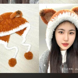 May include: A cozy, orange and white fox ear hat with ear flaps and pom-pom ties. The hat is made of a soft, fuzzy material, perfect for keeping warm. The hat is a fun and playful accessory.