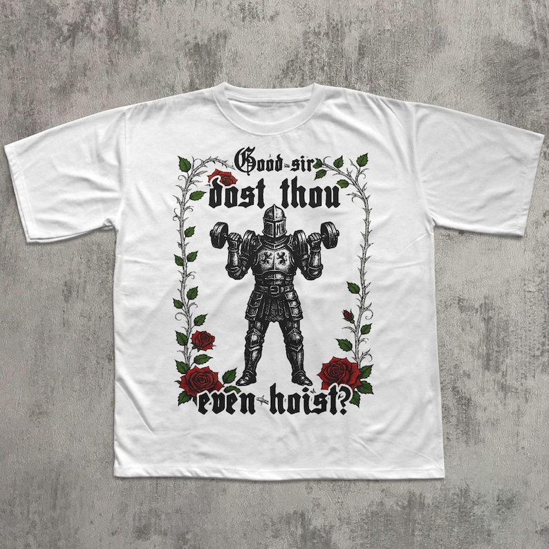 May include: White t-shirt featuring a black and white illustration of a knight lifting dumbbells. The design includes the text "Good-sir dost thou even hoist?" framed by roses and vines. A unique graphic tee for fitness enthusiasts.