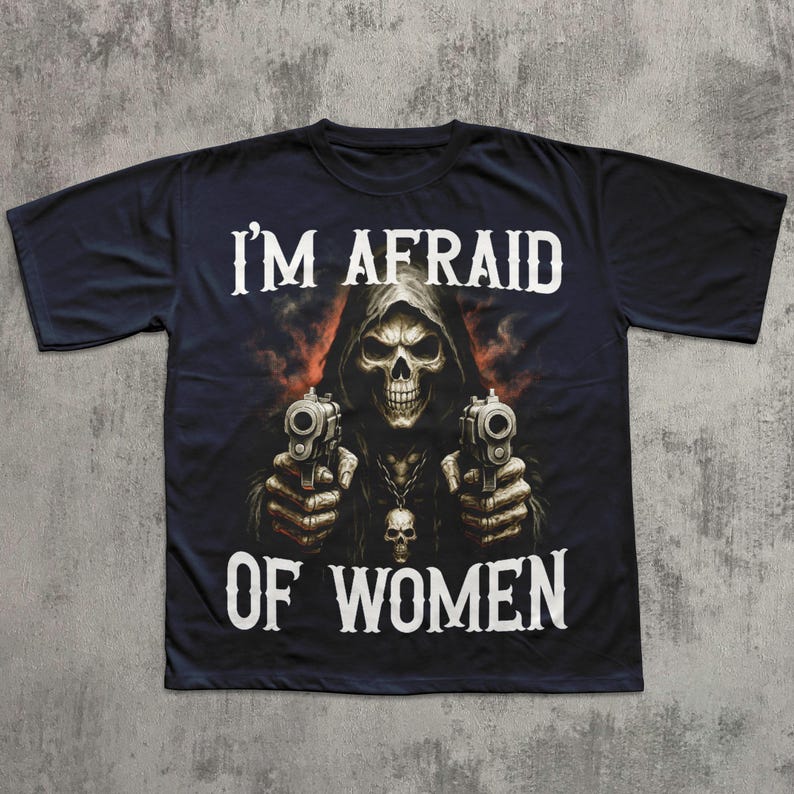 May include: Black t-shirt featuring a grim reaper graphic holding two pistols. The reaper is depicted with a skull face and a hooded cloak. The text "I'M AFRAID OF WOMEN" is printed in white.