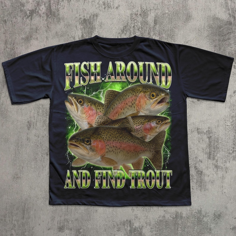 May include: Black t-shirt featuring a graphic of four trout fish with the text "FISH AROUND AND FIND TROUT" in green and white. The fish are brown with red and pink accents, set against a green lightning-like background.