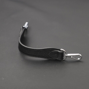 May include: Black leather strap with a silver hook and loop closure.
