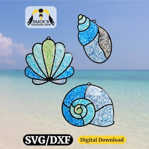 May include: Three stained glass seashell designs in shades of blue, green, and white, with black outlines. The image includes the text "SVG/DXF" and "Digital Download". The background shows a beach and sky.