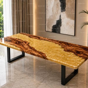 May include: A rectangular dining table featuring a polished yellow onyx stone surface with natural brown wood grain edges, supported by two black metal U-shaped legs. The tabletop displays a smooth, glossy finish with a distinct contrast between the central golden stone and the dark, textured wooden borders.
