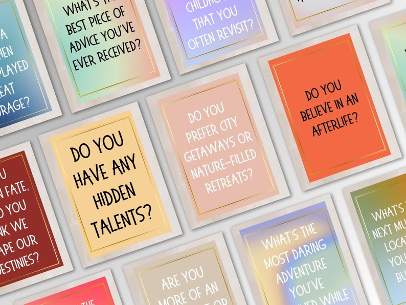 May include: A set of colorful cards with thought-provoking questions for conversation starters. The cards feature a variety of colors and textures, with gold accents.