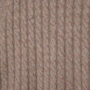 May include: Close-up of a beige cable knit sweater. The knit pattern features vertical columns of intertwined cable stitches. The fabric has a soft texture and subtle flecks of blue and brown throughout, adding visual interest to the design.