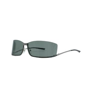 Gafas de sol vintage Gucci GG 1713 de los años 90, sin montura, estilo envolvente, con montura color gris plomo, lentes gris humo, logotipo, remaches, montura perforada, unisex, hechas en Italia.