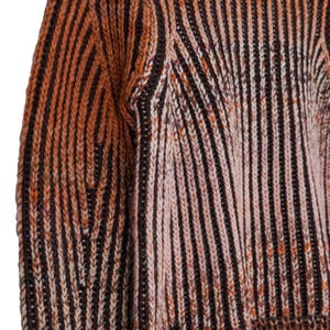 May include: Close-up of a knitted sweater with vertical stripes in shades of brown, orange, and cream. The knitwear features a textured pattern and a subtle color gradient, creating a warm and inviting aesthetic.