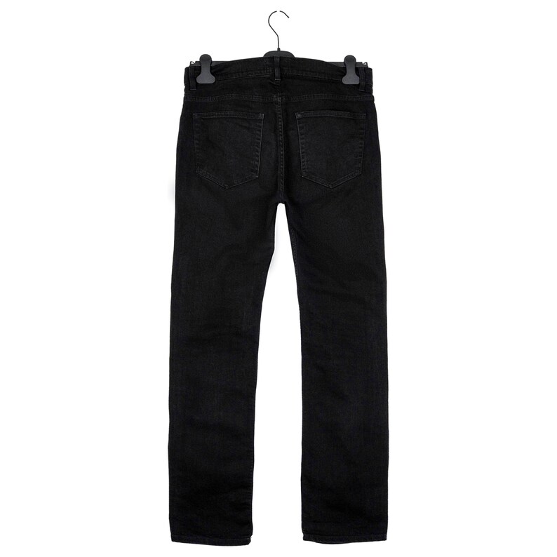 May include: Black denim jeans hanging on a black hanger. The jeans have a classic five-pocket design with a straight leg. The back pockets are visible, and the jeans appear to be a solid, dark color.