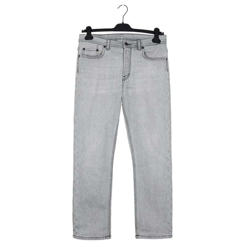 May include: Light gray denim jeans hanging on a black hanger. The jeans have a classic five-pocket design with a button and zipper closure. The denim appears to be a medium weight, suitable for various seasons.