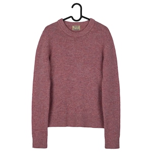 May include: A dusty rose crew neck sweater with long sleeves, hanging on a black hanger. The sweater has a ribbed hem and cuffs. A small tag with the text "Acne Studios" is visible near the neckline.