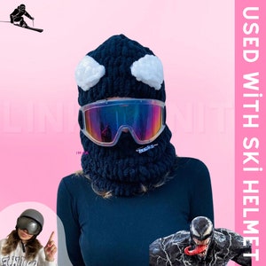 May include: Black knit ski mask with white eye details and a black ski goggle. The text "USED WITH SKI HELMET" is in the upper right corner of the image.