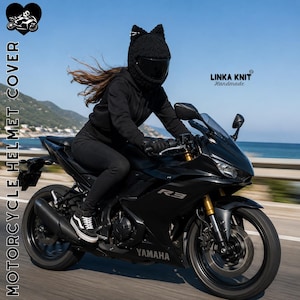 May include: A black crocheted motorcycle helmet cover featuring two pointed cat ears on top. The cover is worn over a full-face helmet, which has a dark tinted visor. The text "MOTORCYCLE HELMET COVER" and "LINKA KNIT Handmade" appear on the image.