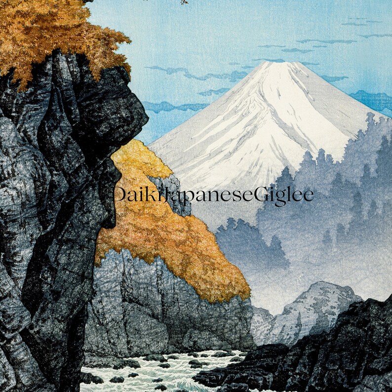 Pu&ograve; includere: Una stampa giapponese su legno che raffigura il Monte Fuji, una montagna innevata, sullo sfondo. In primo piano, un letto di fiume roccioso con un torrente e una scogliera rocciosa ricoperta di foglie autunnali.