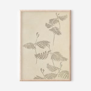 May include: A framed botanical print featuring a beige background with detailed illustrations of fern-like plants in shades of gray. The artwork has a minimalist aesthetic, with a focus on natural forms and textures. The wooden frame adds a touch of warmth.