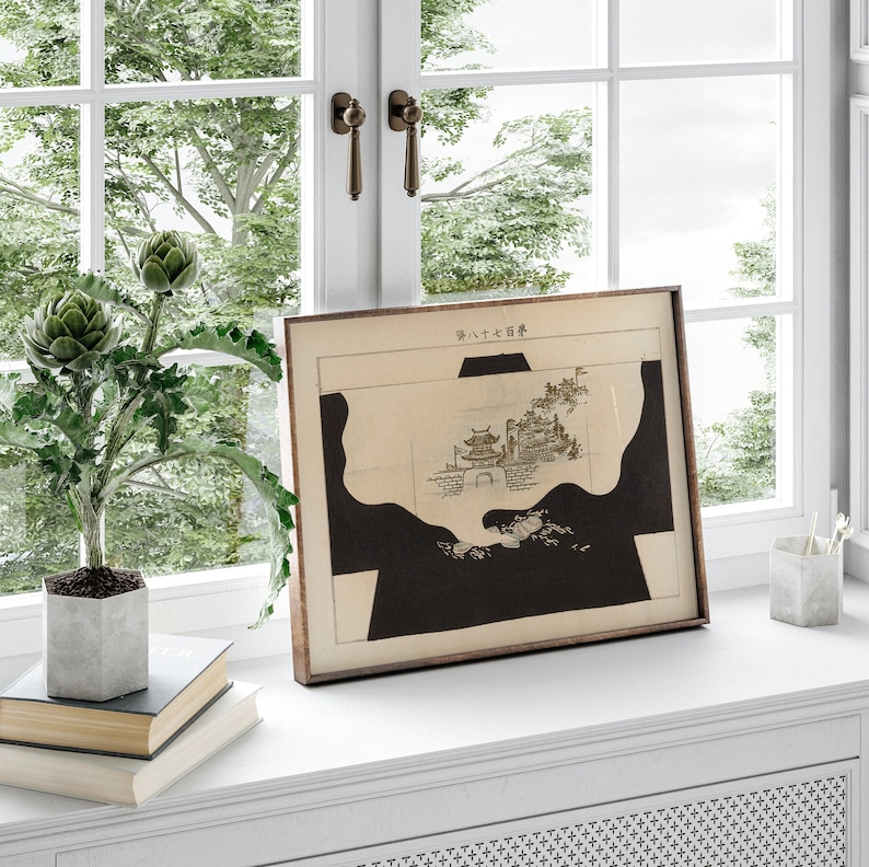 May include: A framed black and white print of a Japanese landscape with the text "第八十六番" in the top right corner. The print is on a white background and is framed in a brown wood frame.