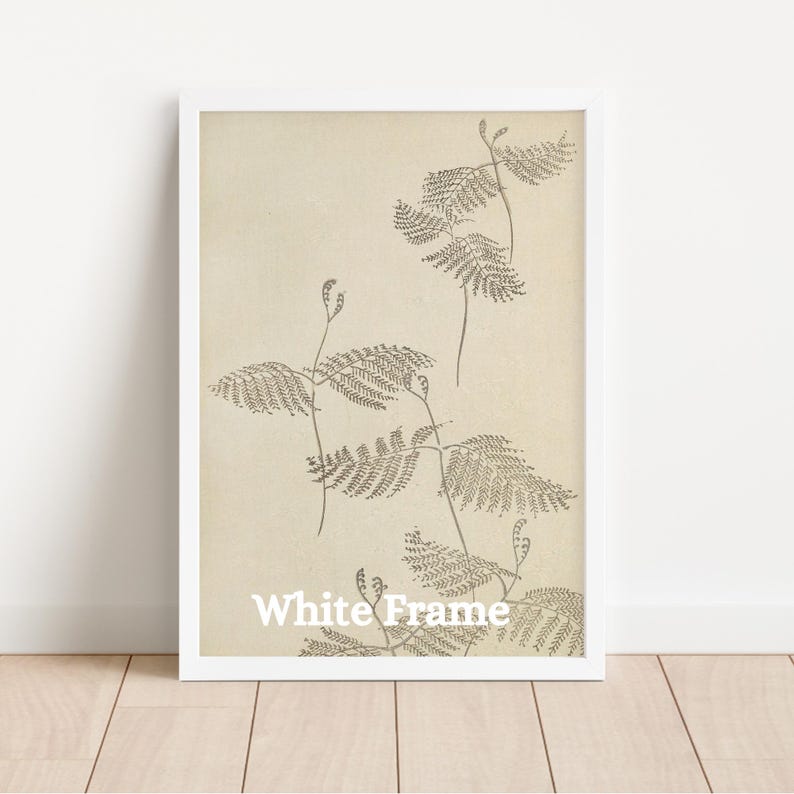 May include: White framed botanical print featuring detailed illustrations of fern-like plants in shades of brown against a cream-colored background. The text "White Frame" is printed at the bottom. The artwork is encased in a white frame.