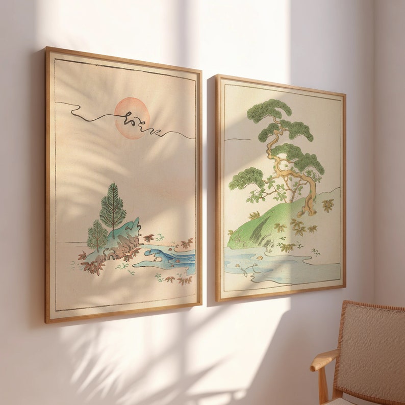May include: Two framed prints with a Japanese aesthetic. The print on the left features a stylized landscape with a sun, a river, and a small island with trees. The print on the right features a stylized landscape with a large tree, a river, and a small island with trees.