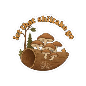 May include: A sticker featuring a log with several brown shiitake mushrooms growing on it. The sticker has the text "Let that shiitake go" in orange lettering. A small tree and pine tree are also in the image.