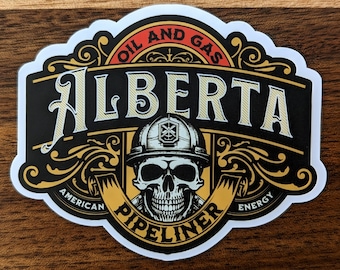May include: A white sticker with a black and gold design. The sticker features a skull wearing a hard hat with the words "Oil and Gas Alberta" above the skull and "American Pipeliner Energy" below the skull.