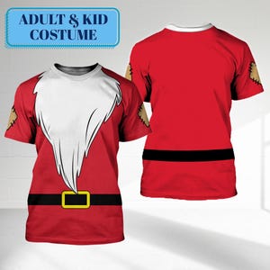 May include: Red t-shirts with a Santa Claus costume design. The front of the shirt features a white beard, black belt with a gold buckle, and brown patches on the sleeves. The text "ADULT & KID COSTUME" is in a blue box.