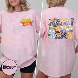 May include: Pink t-shirt with a graphic of Toy Story characters spelling out "Mama" on the back and "Mom Life" on the front.