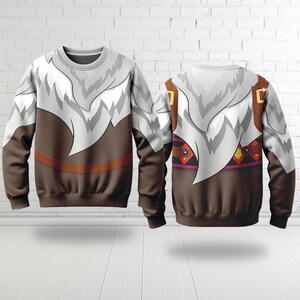 May include: Crew neck sweatshirt featuring a design that resembles a character's outfit. The top portion is white with a fur-like pattern, transitioning to a brown midsection with a brown belt detail. The back of the sweatshirt is also visible.