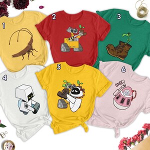 May include: Six different t-shirts featuring various designs from the film Wall-E. The designs include Wall-E, Eve, the cockroach, the boot, the plant, and the robot.