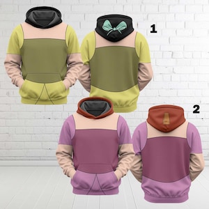 May include: Three hoodies with cartoon-style designs. One is yellow, olive green, and tan with a black hood. The second is purple, tan, and pink with a brown hood. The third is yellow, olive green, and tan with a black hood and a teal bow.